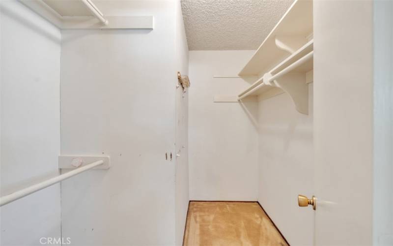 Primary bedroom walk in closet