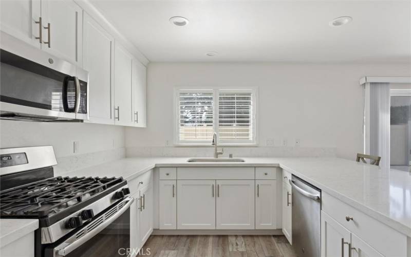 Quartz countertops and stainless appliances.