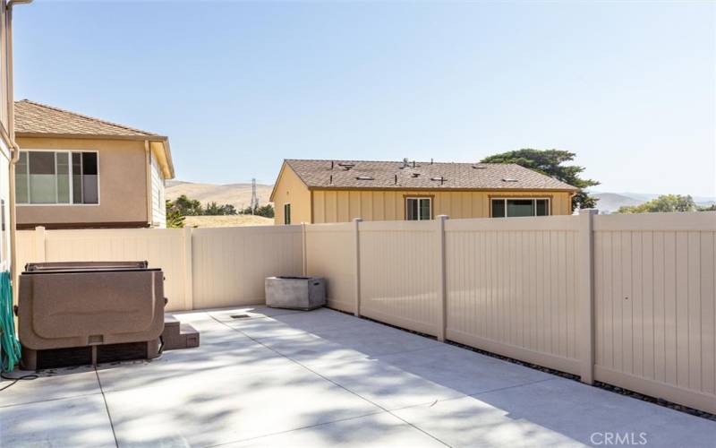 Concrete backyard with fully fenced yard.