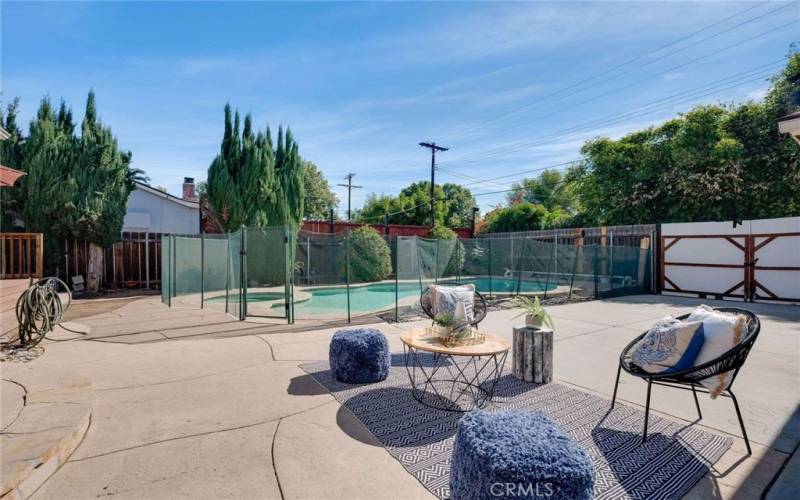 Expansive back patio area with pool, spa, 2 entertaining spaces, and possible RV parking