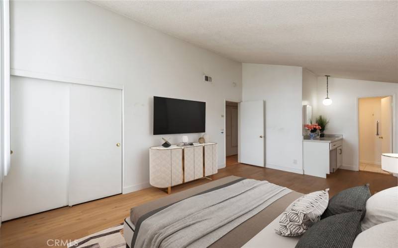 virtually staged primary bedroom leading to primary bathroom