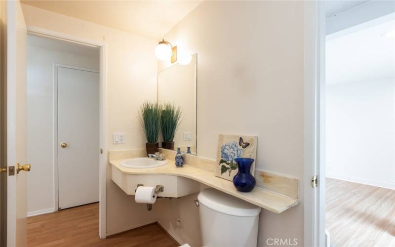 downstairs powder room at the base of the stairs leading back to the front door