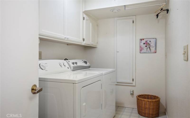 Laundry room next to attached garage.