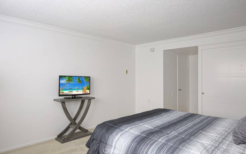 Here's the primary bedroom looking from the windows toward the dressing area.