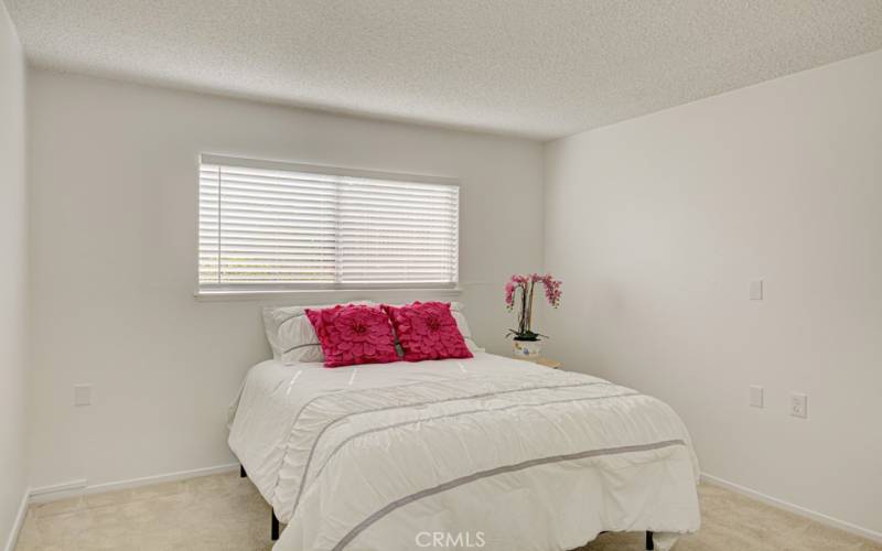 The first bedroom is spacious and has ample room for large pieces of furniture.  The bed in the photo is a queen size bed.