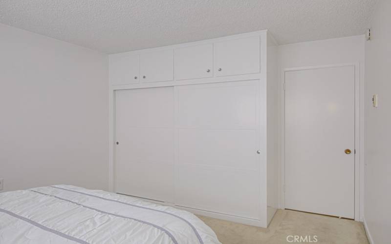 Here's the large closet with cabinets above in the first bedroom.