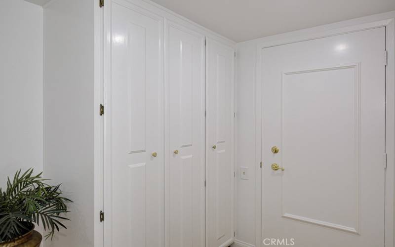 The doors on the left are the entry closet.  The door on the right is the front door.  The paneled doors add a touch of elegance.  The fresh paint gives everything an inviting fresh, clean appeal.