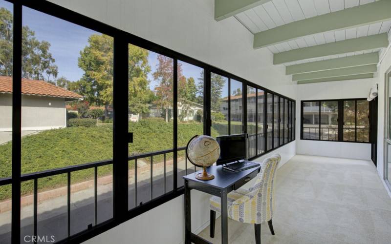 The enclosed patio room is carpeted and the windows are sceened.  What a beautiful greenbelt view!