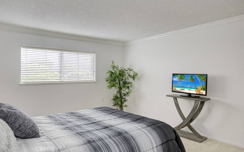 Here's the primary bedroom looking from the dressing area toward the windows.