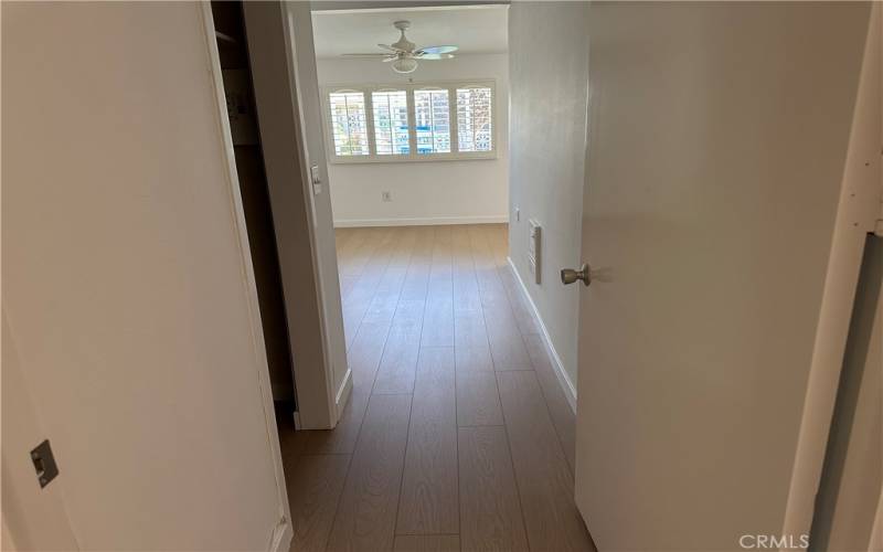 Hall entry to large primary bedroom