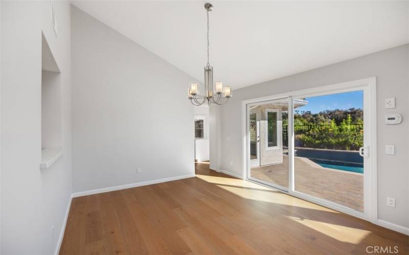 Open dining area with views to the pool in the backyard.