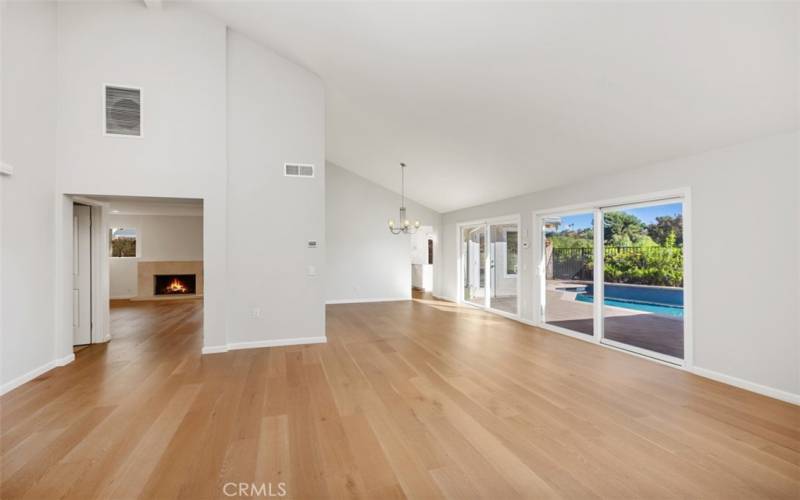 Living room showing sliding glass doors leading to the backyard and then den to the left.