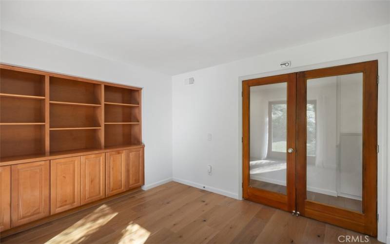 Office or bedroom with glass doors to the hallway