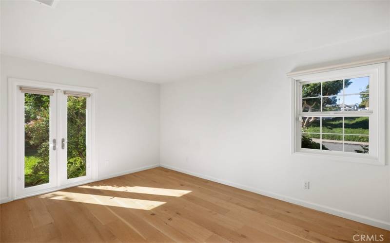 Guest Bedroom #1 at the front of the house with french doors leading outside.