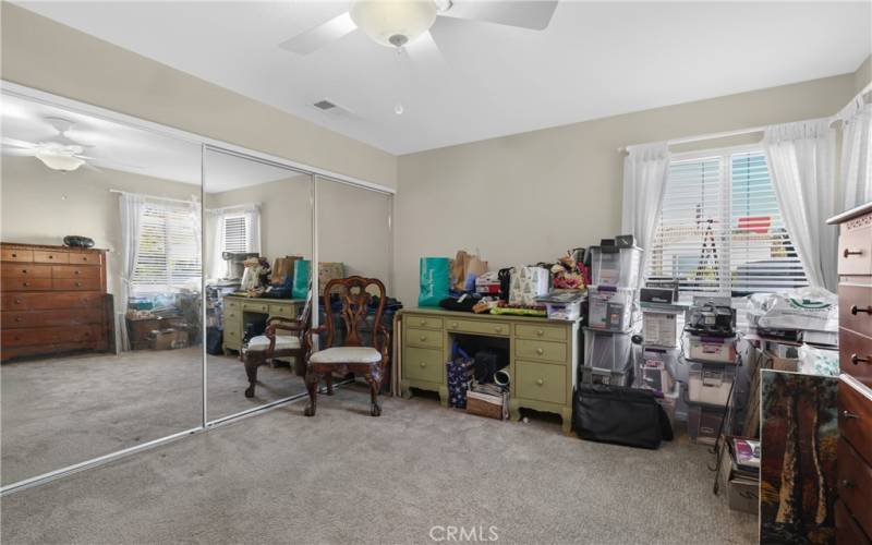 Guest bedroom with a large wall closet.