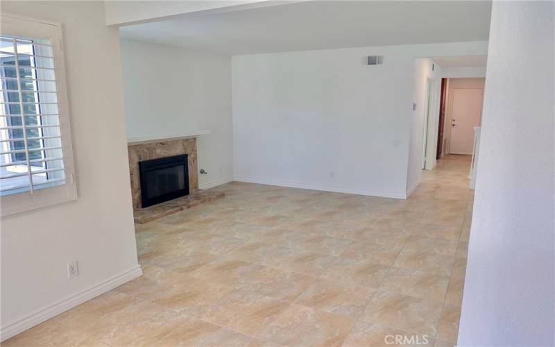 Family room with gas fireplace - plantation shutters - off kitchen and entry