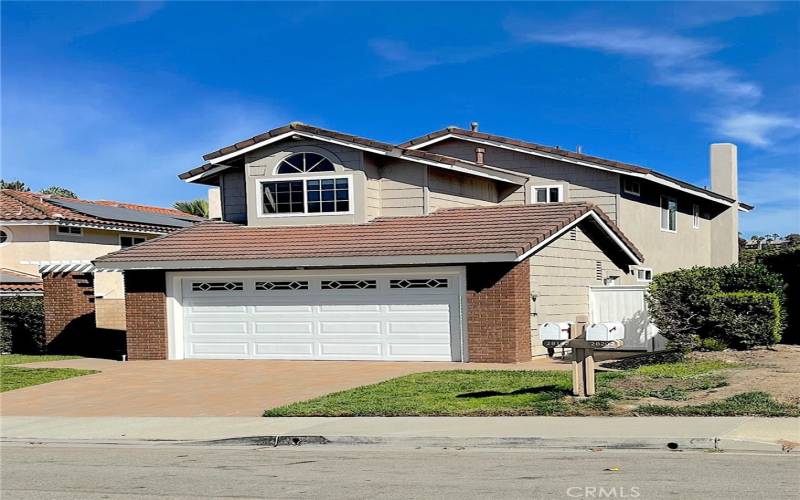 Freshly Painted Exterior. New Landscaping, paver driveway and walkways.