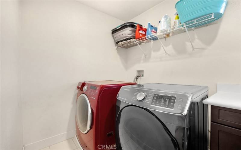 upstairs laundry room with utility sink and storage.