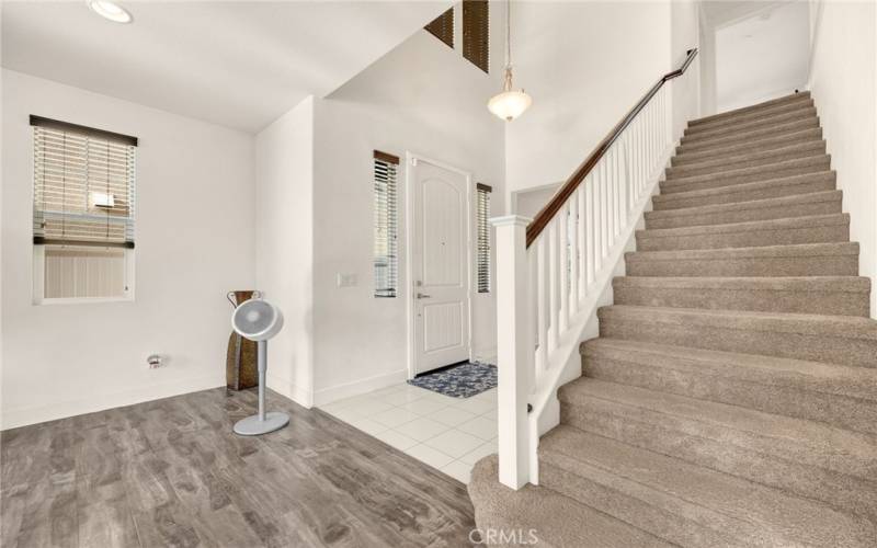 wide staircase leading up to 3 additional bedrooms and a loft.