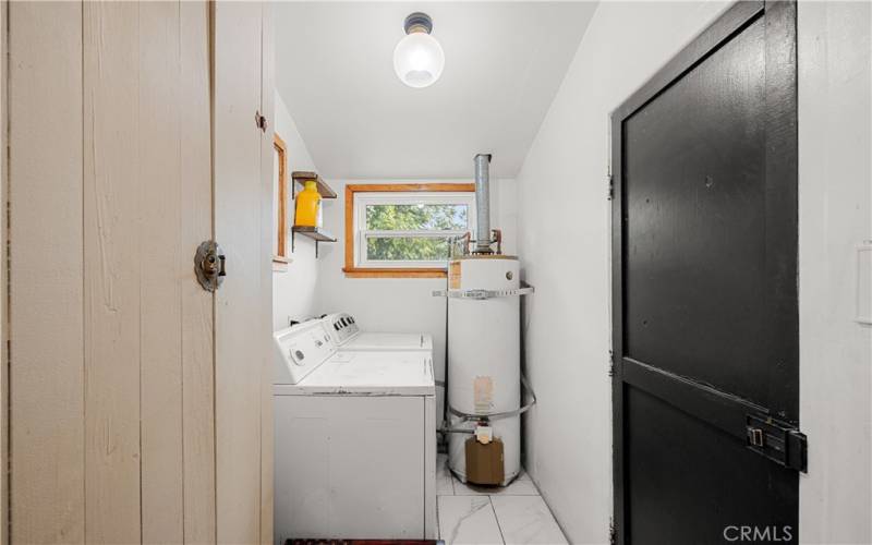 indoor laundry with door leading to the backyard