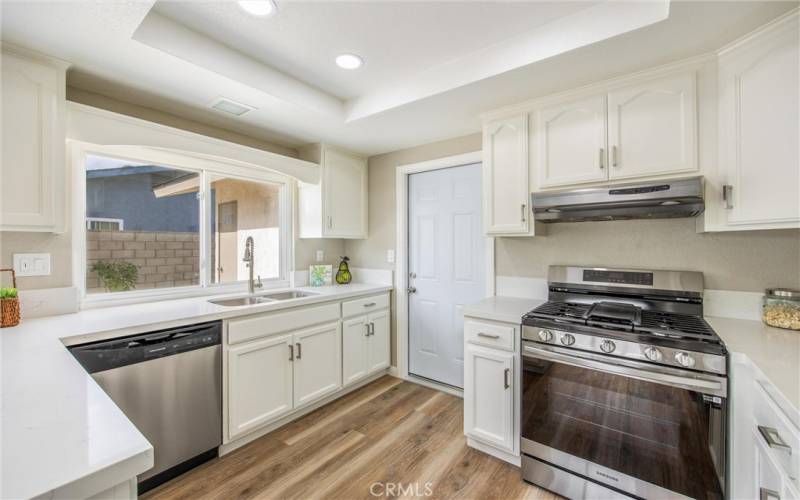 Kitchen with new stove and dishwasher