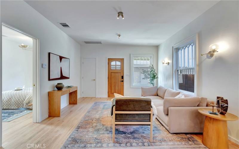 Living room with 9 ft ceilings, mid-century modern brass fixtures and new hardwood floors