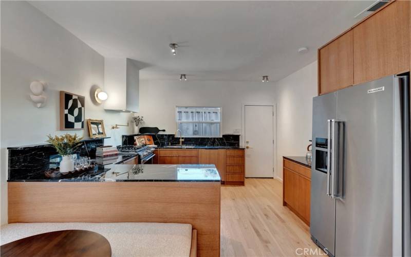 Kitchen with beautiful marble countertops and KitchenAid fridge