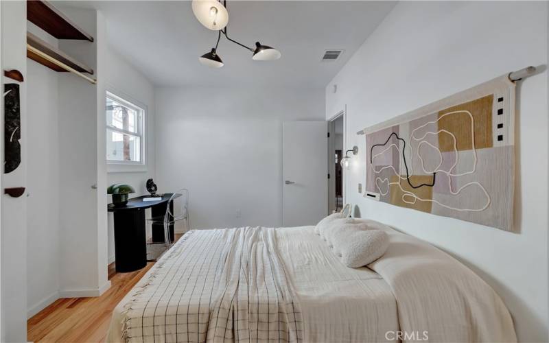 Primary bedroom with dimmable sconces by the bed