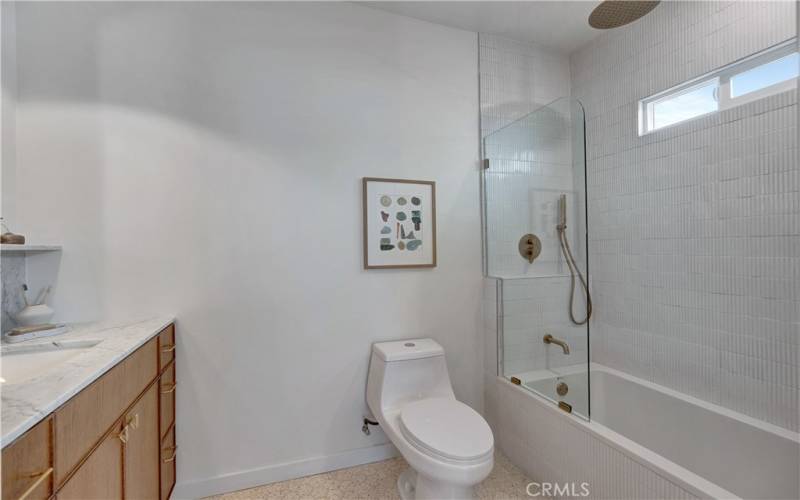 Bathroom 2 with soaking tub, statement vertical tile, and dual rain shower and handheld shower options