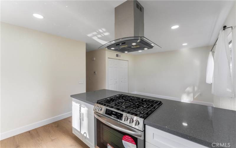 Remodeled kitchen opens to the dining area and laundry closets and pantry.