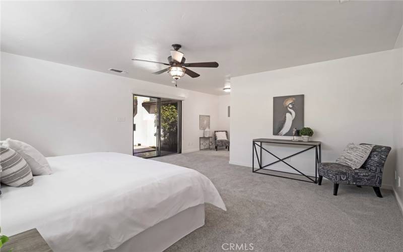 Primary bedroom with sliding glass door to backyard