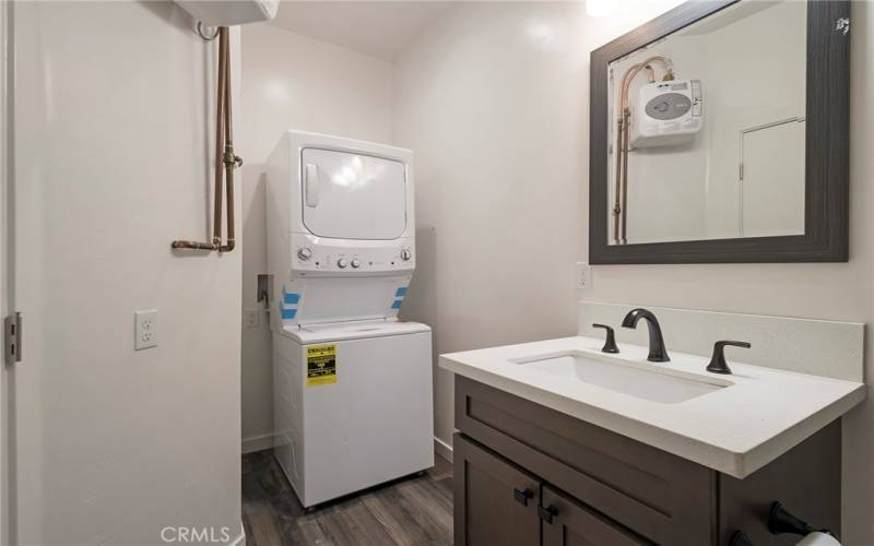  Bath room with stackable washer/dryer and on demand water heater