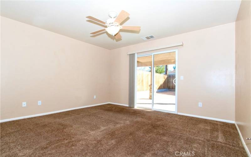 Primary bedroom with sliding glass door to backyard