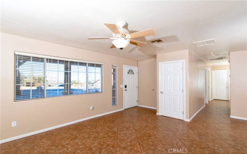 Living room with coat closet at entry