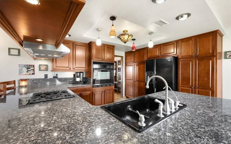 Primary Home - Kitchen with Features Beautiful Cherry Wood Cabinetry and Granite Countertops