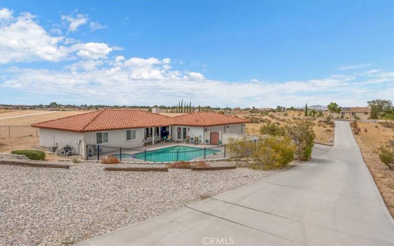 Home #2 - View from upper drive of Driveway. Pool area is fully fenced