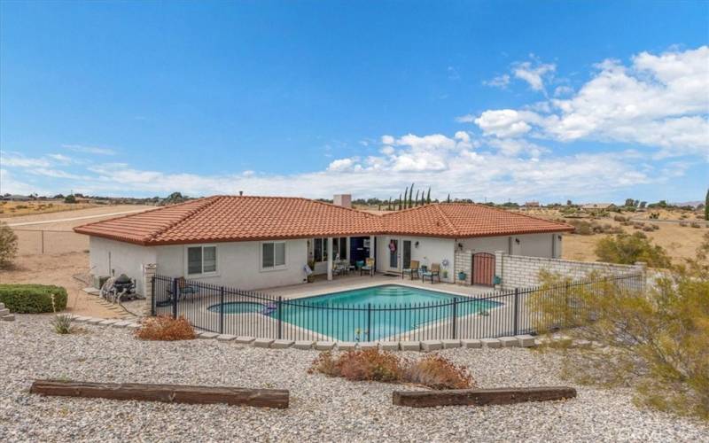 Home #2 - Enclosed pool area surrounded by easy to maintain rockscape