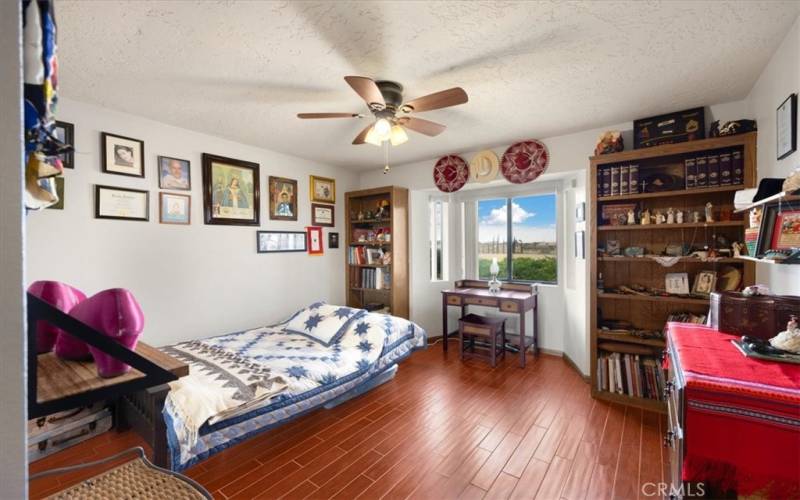 Primary Home - Bedroom #3 with Bay Window, Wood Look Flooring and Built in Bookshelves