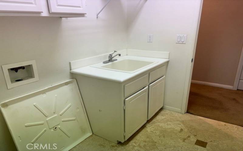 Upstairs Laundry with cabinets and sink