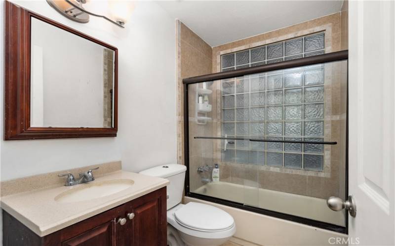 Guest Bath with a shower in a tub.