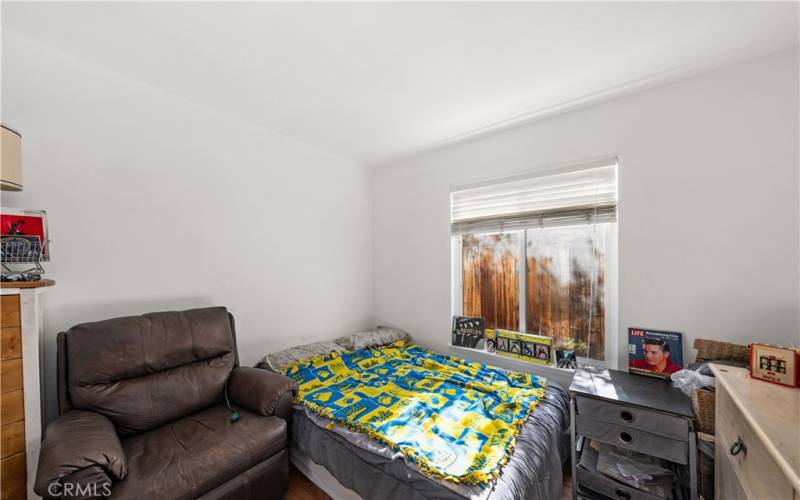 Guest room with window with blind for natural light.