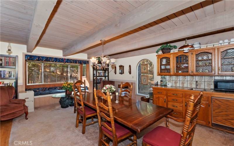 dining room with wet bar and beautiful view of trees