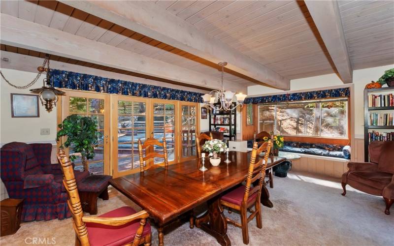 Dining room with wall of doors opening to back deck and patio