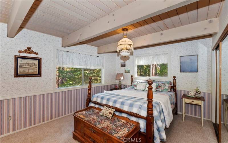 Primary bedroom with views of the forest