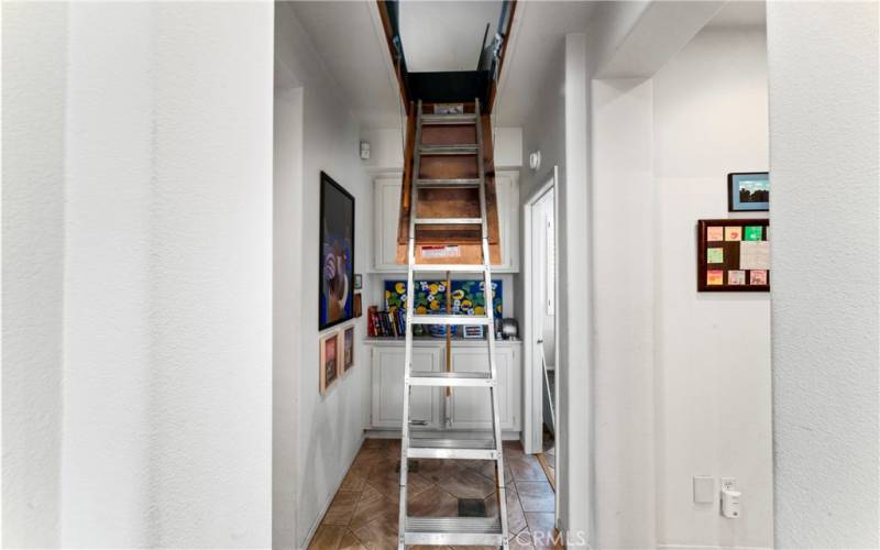 Finished attic that is carpeted, lighted and has bookshelves.