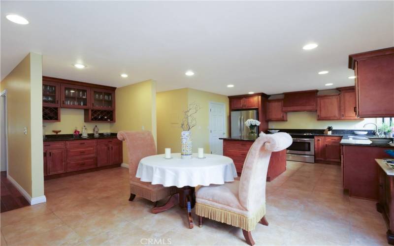 Eating Area Adjacent to Kitchen with Entertaining Custom Bar