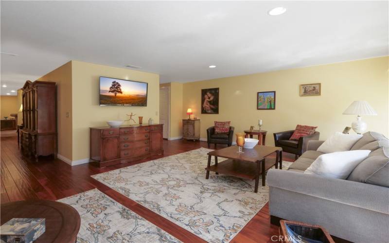 Living Room with Maple Wood Floors Leads to Dining Room