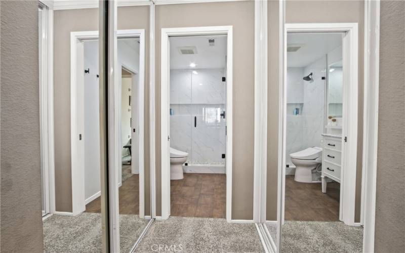 Two separate primary bedroom mirrored closets