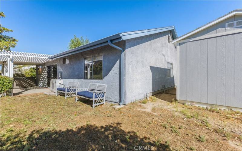 Left side of the house showing the larger of 2 storage sheds