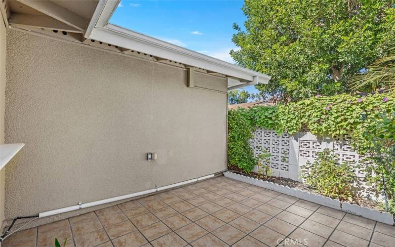 Large front patio with planting area.